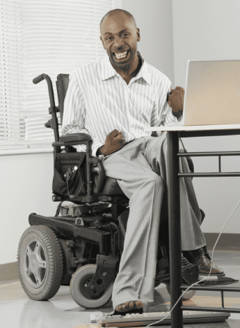 A man with cerebral palsy using his feet to type 